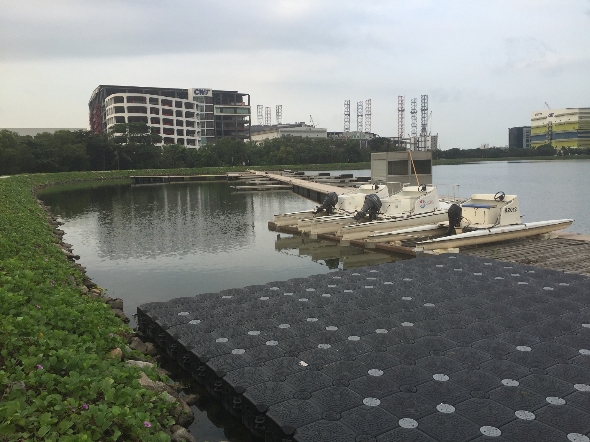 Motorized boats resting alongside floating platforms.