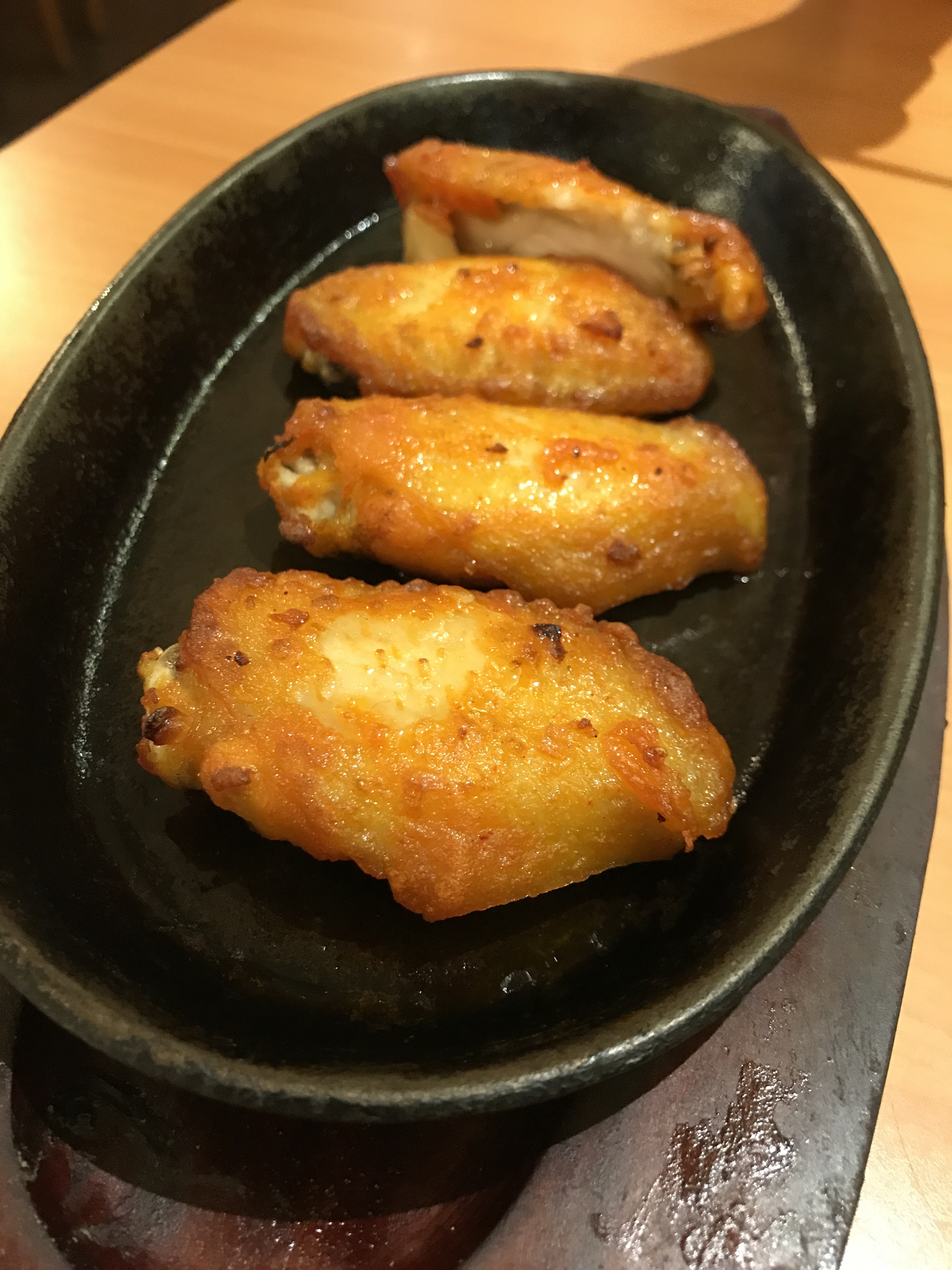 A little crispy, sticky, juicy and tender. Served on hot plate.